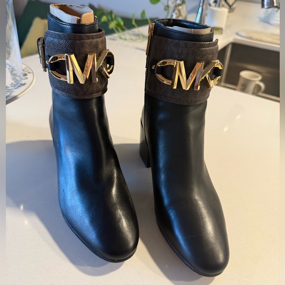 Michael Kors Izzy Bootie. Black and Brown with Gold MK Logo and side zipper.